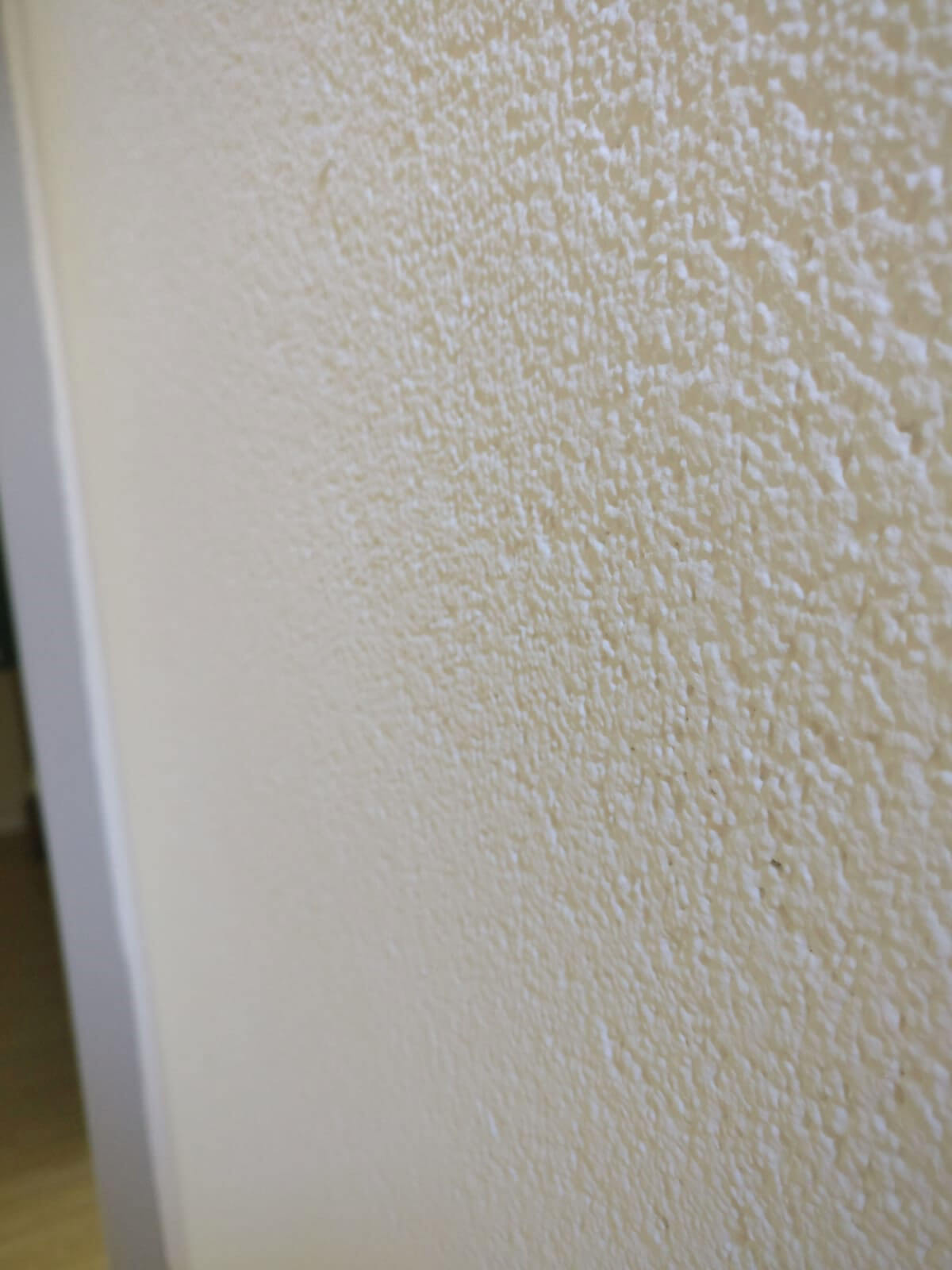 Spachtelputz op een muur bij een deur